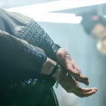 Captured criminal in cuffs bending forwards