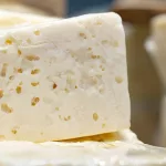 Piece of cheese on display in supermarket