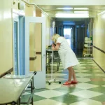 A pregnant woman stands in the corridor of a maternity hospital before giving birth