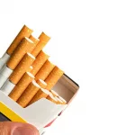 hand-holding-a-pack-of-tobacco-with-cigarettes-pou-2023-11-27-05-08-35-utc